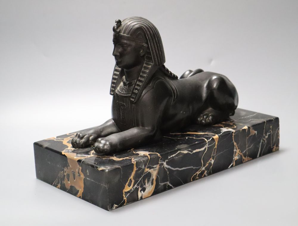 A bronzed spelter and marble sphinx, on marble plinth, height 32cm
